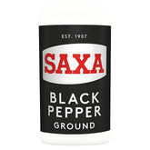 A 25g container of Saxa Ground Black Pepper, featuring a black and white label with "Saxa" in red and "Est. 1907" at the top.